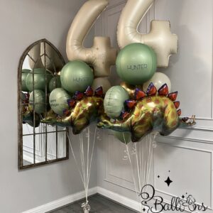 Luxury personalised dinosaur birthday balloon display with large foil numbers and helium balloons in London